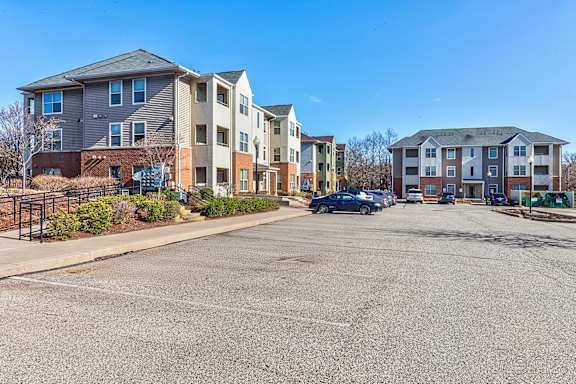 A parking lot in front of apartment buildings.