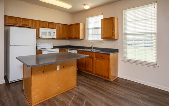 a kitchen with wooden cabinets and a white refrigerator