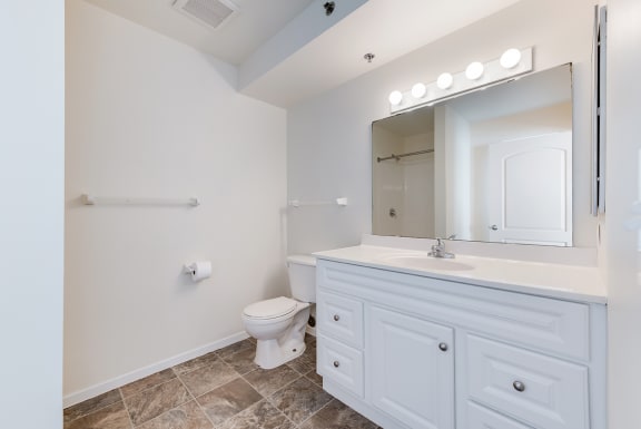 a white bathroom with a toilet and a sink Fall Leasing & Recertification Incentives