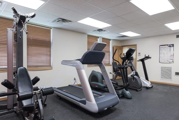 a gym with treadmills and other exercise equipment at Heritage Park apartments and townhomes in Minneapolis, MN