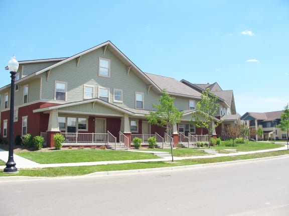 a row of houses on the side of a street at Heritage Park apartments and townhomes in Minneapolis, MN