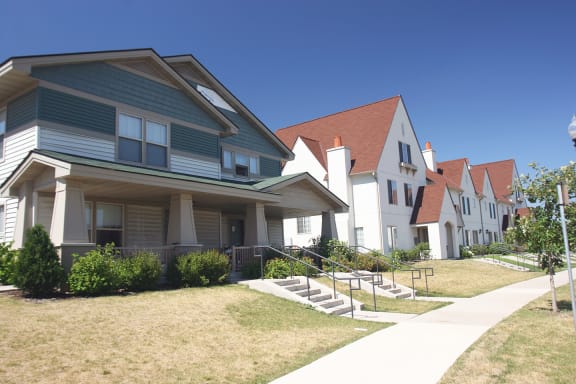 a row of houses on the side of a sidewalk at Heritage Park apartments and townhomes in Minneapolis, MN
