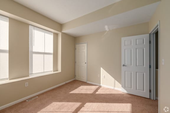 an empty room with a door and a window