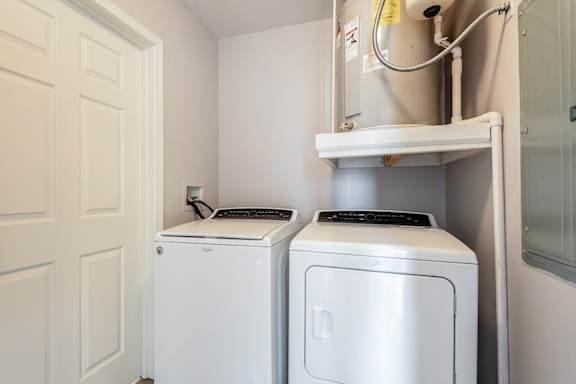 A small laundry room with a washer and dryer.