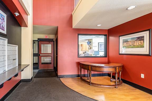 A hallway with a wooden table and a painting on the wall.