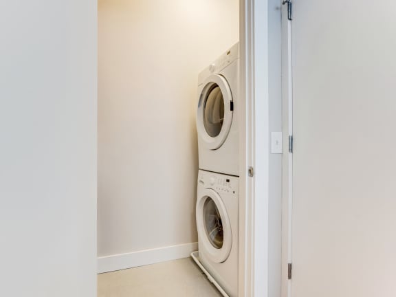 a front loading washer and dryer in a laundry room