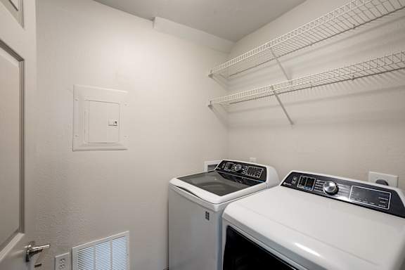 A small laundry room with a washer and dryer.