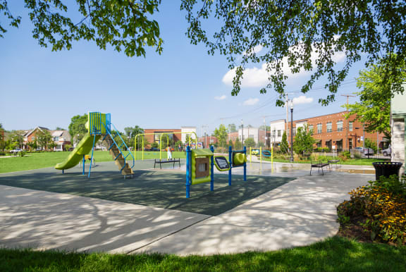 a playground with slides and swings in a park
