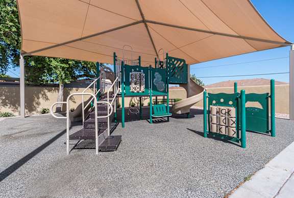 A playground with a slide, swings, and a climbing frame.