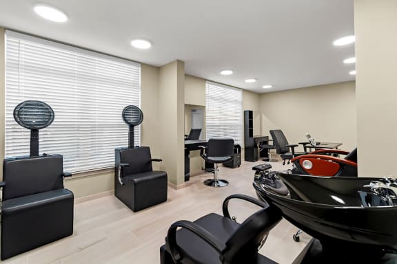 a salon with chairs in a room with windows at South City Senior in Memphis, TN