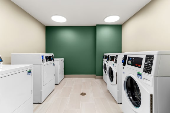 a laundry room filled with washes and dryers at South City Senior in Memphis, TN