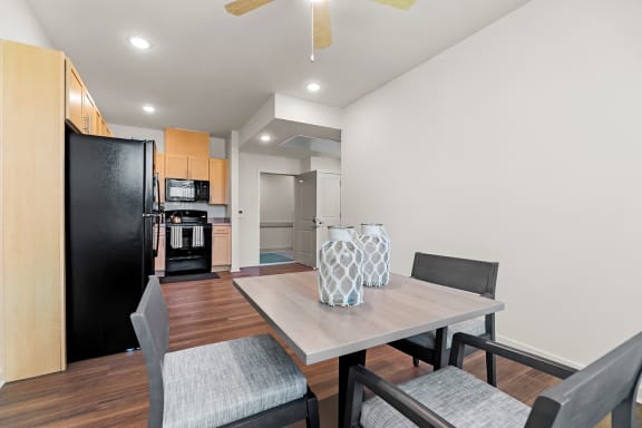 a living room and kitchen with black appliances at South City Senior Apartments in Memphis, TN