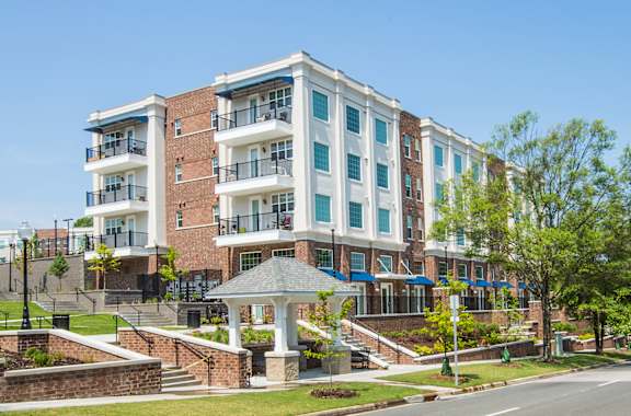 A large apartment building with a gazebo in front.