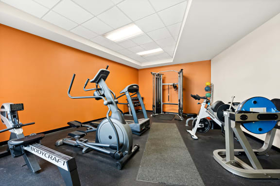 an indoor gym with exercise bikes and weights