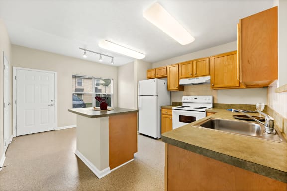 a kitchen with white appliances and wooden cabinets