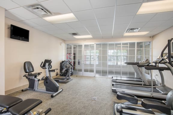 the gym with treadmills and exercise equipment at the University Place Apartments & Townhomes