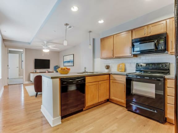 a kitchen with a stove top oven and a sink