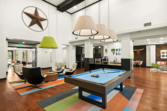 a living room with a pool table in the middle