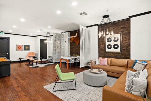 a living room with a brown couch and a green chair