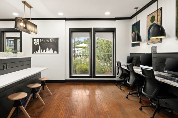 a conference room with desks and chairs and a window