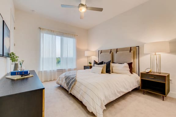 a bedroom with a large bed and a mirror
