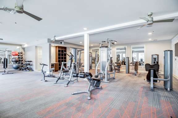 A spacious gym with a variety of equipment.