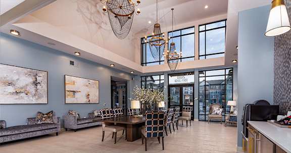 A modern dining room with a large table and chairs.