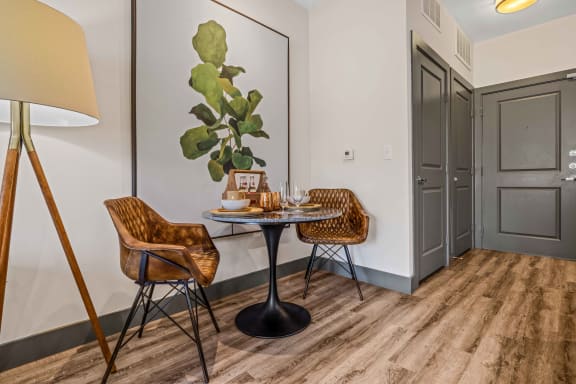 a dining area with a table and two chairs