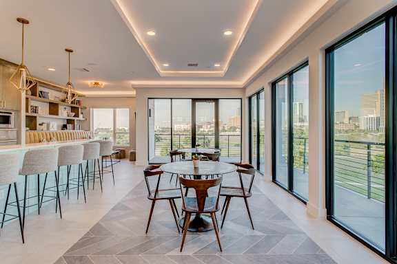 A modern dining room with a view of the city.