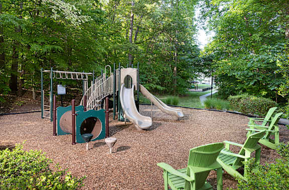 A playground with a slide, swings, and a climbing frame.