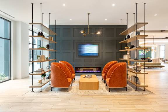 a living room with a table and chairs and a television