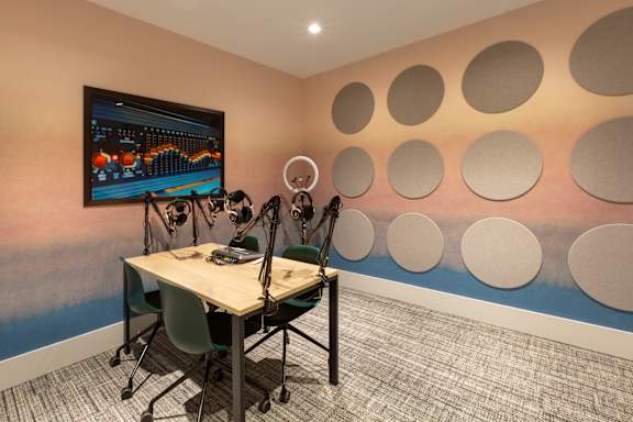 a conference room with a table and chairs and a wall with circles on the wall