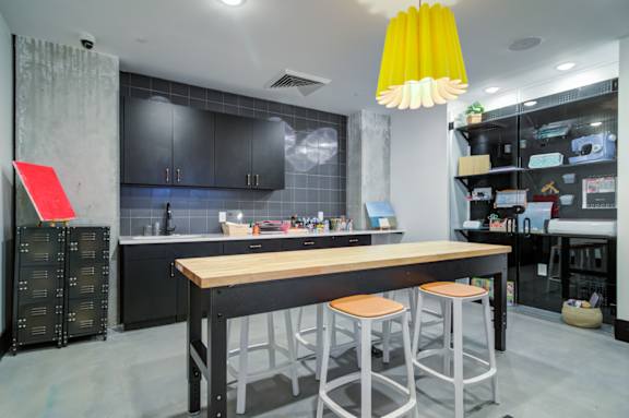 A modern kitchen with a wooden island and bar stools.
