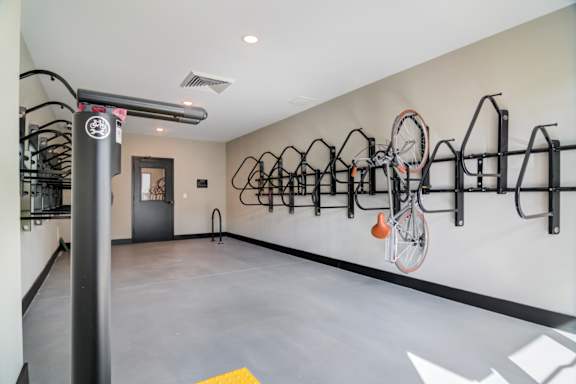 A bike rack with bicycles in a room.