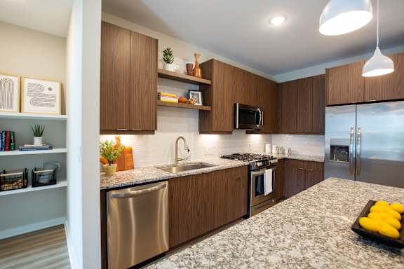 A modern kitchen with wooden cabinets and stainless steel appliances.