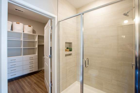 A bathroom with a walk-in shower and a pantry.