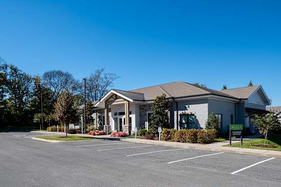 A building with a parking lot in front of it.