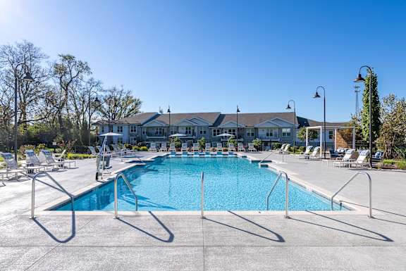 A large swimming pool with a metal fence around it.