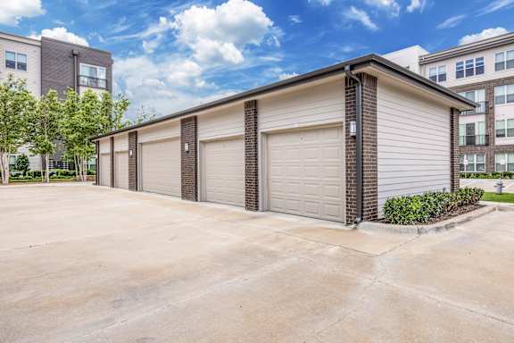 A two-car garage with a brick pillar in front.