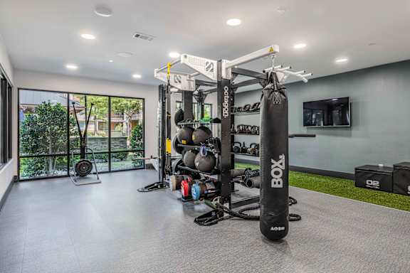 A home gym with a punching bag and various exercise equipment.