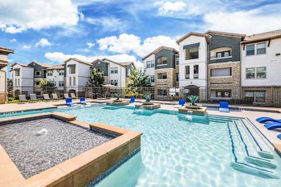 A swimming pool surrounded by residential buildings.