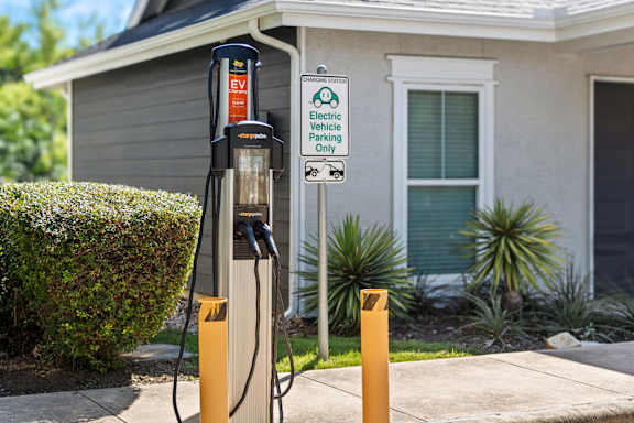 An electric vehicle charging station is located outside a house.