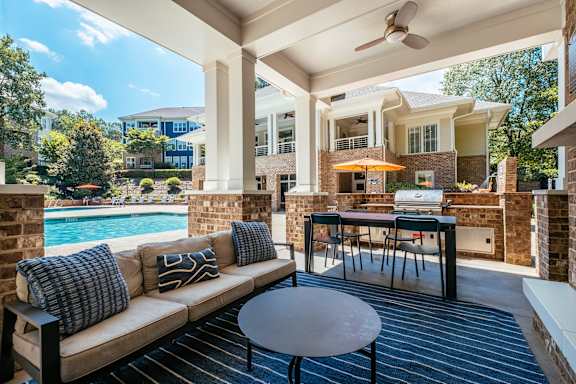 A patio with a couch, table, and chairs is shown.