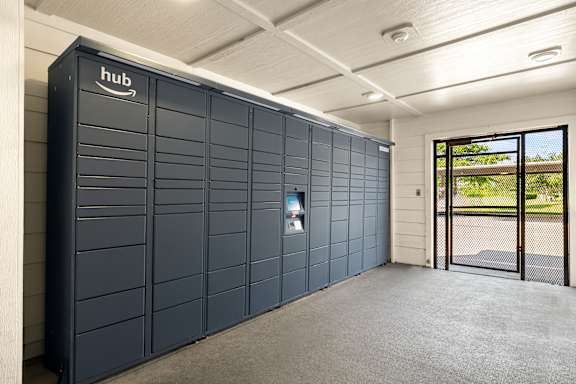 A large, dark-colored Amazon storage unit is situated in a spacious, well-lit room.