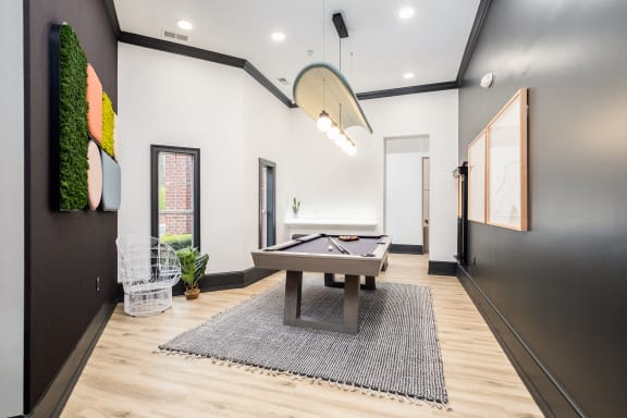 a game room with a pool table and a ping pong table