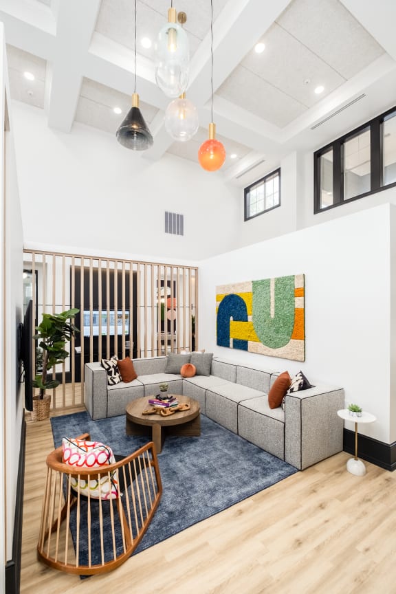 a living room with a couch and chairs and a rug