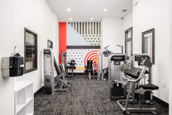 a gym with cardio machines and other exercise equipment in a building