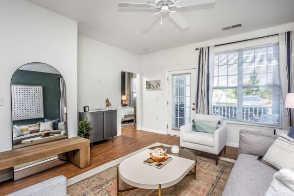a living room with white walls and hardwood floors