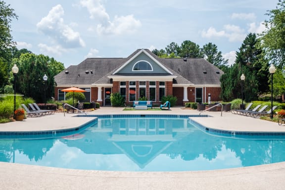 a large swimming pool in front of a house