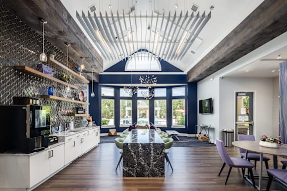 A modern kitchen with a black countertop and a large island in the center.